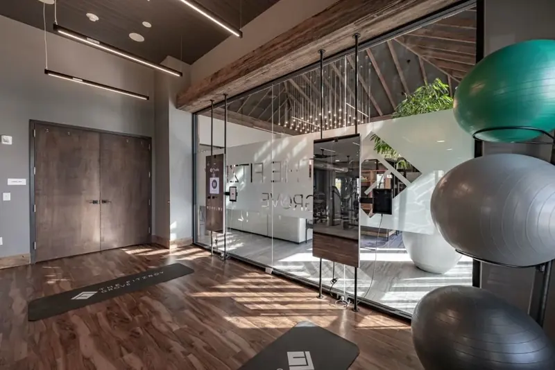 Fitness studio with interactive workout mirrors, yoga mats and stability balls